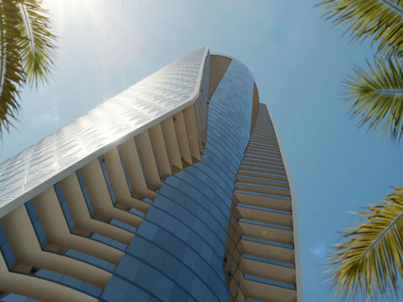 Bentley Residences tower in Sunny Isles Beach seen from below among palm trees